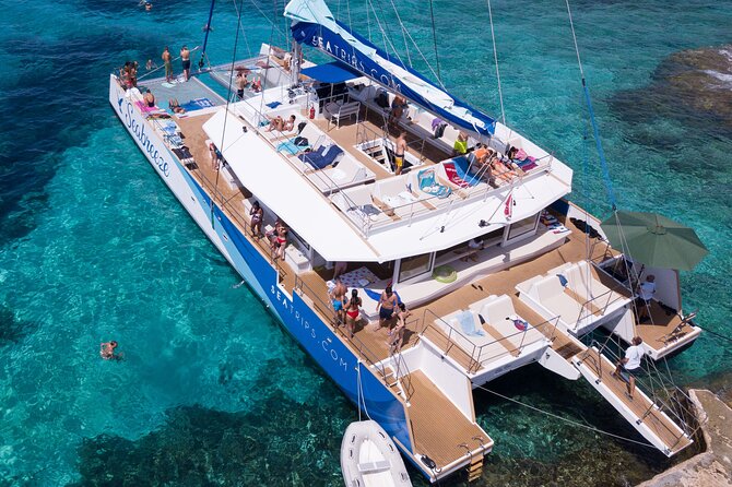 Blue Lagoon, Beaches and Bays Catamaran Sailing Tour - Ghajn Tuffieha Bay: Sandy Time, Nets, and a Break From Pure Water