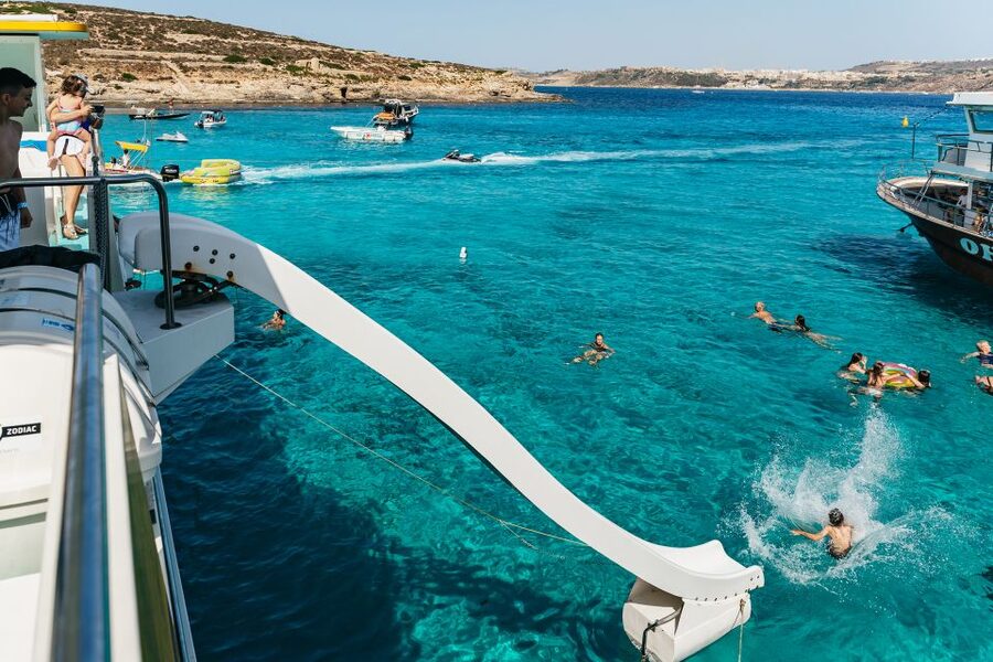 Comino: Blue Lagoon, Crystal Lagoon, and Seacaves Tour - The waterslide and underwater windows, the fun extras that actually get used