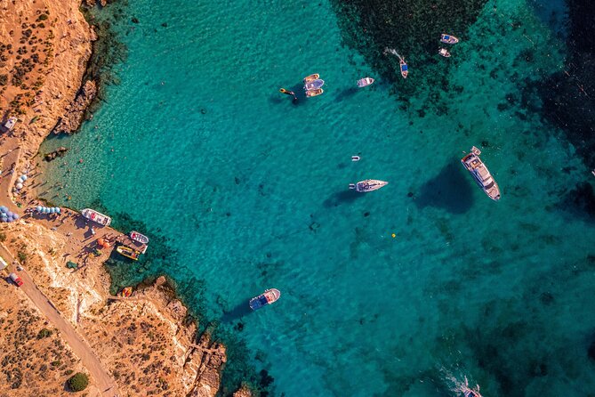 Boats moored in the Blue Lagoon between Comino and Cominotto