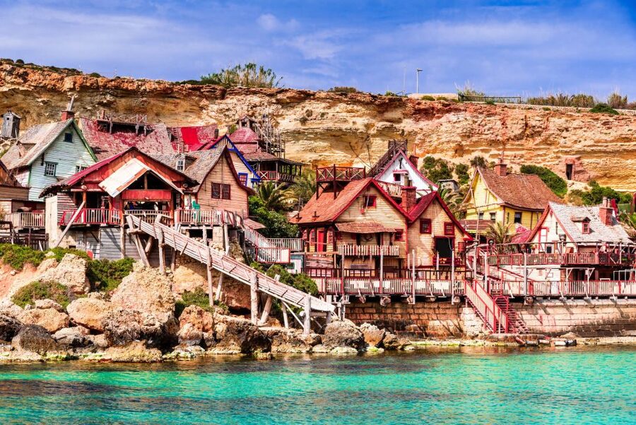 Mellieha: Popeye Village with Optional Private Transfers - Anchor Bay lido time: sun beds, loungers, and the best summer features